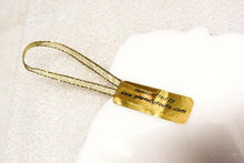 Load image into Gallery viewer, The backside of an acrylic photo cutout ornament with gold ribbon.